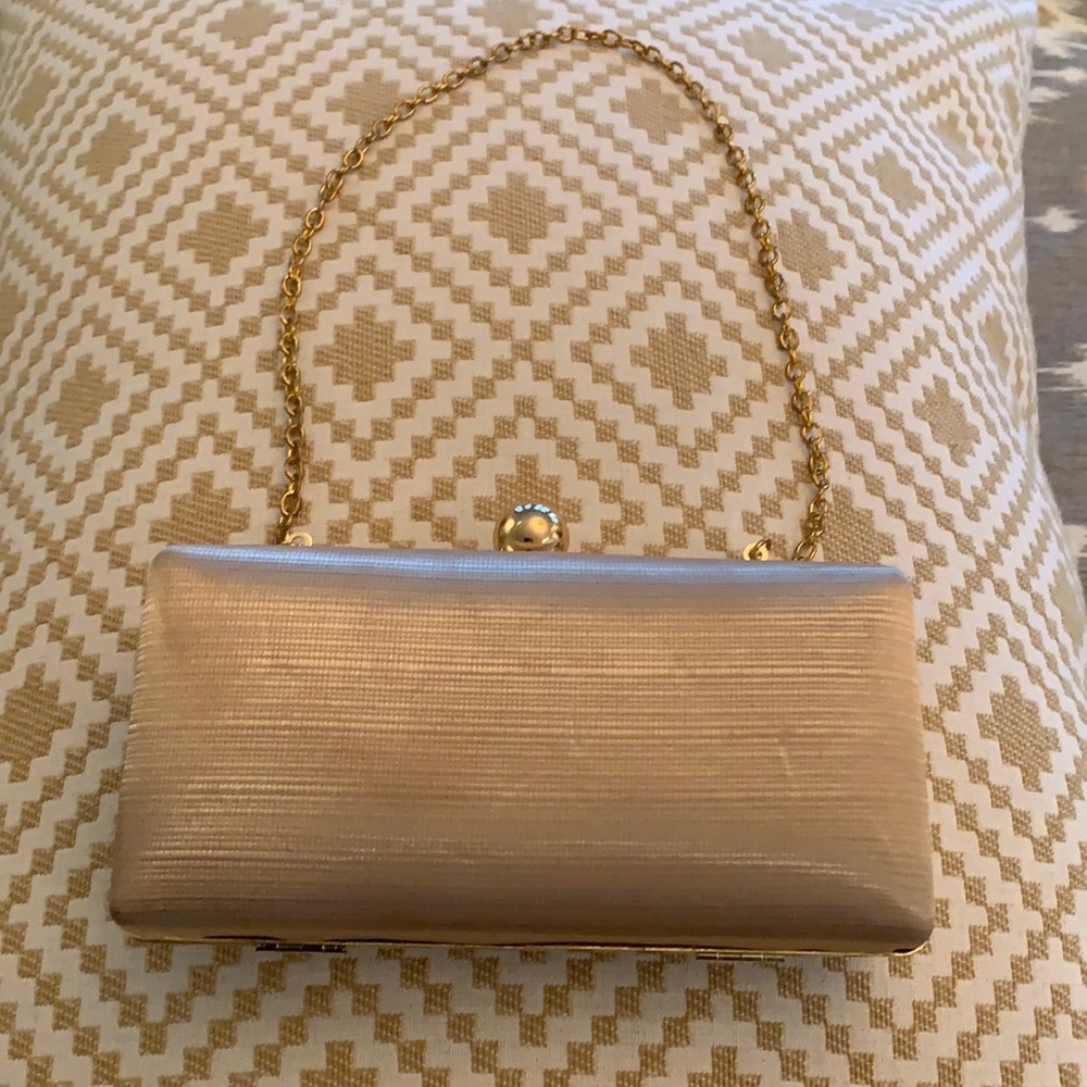 Ladies mini clutch with gold accents.
